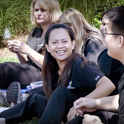 A candid picture of a Georgia Massage School student smiling at the camera.