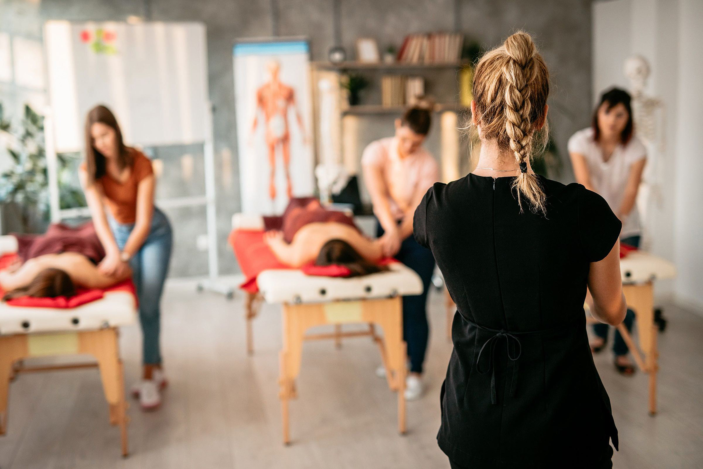Massage Instructor Teaching Students in Class